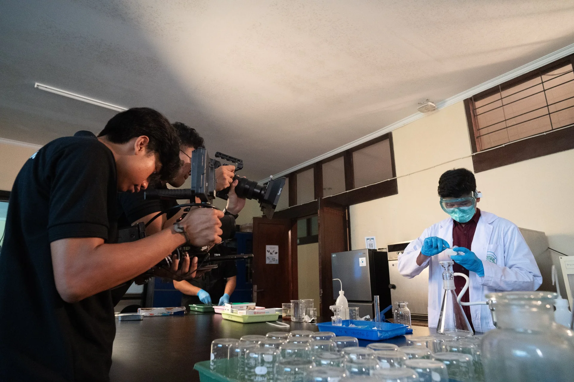TDR FILMS filming a lab scientist operating a fluidity tester for an engineering equipment video production in Jakarta