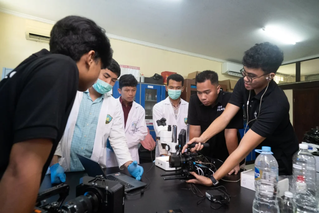 TDR FILMS crew reviewing footage with UI researchers during an innovation documentary shoot on ceramic foam filter research