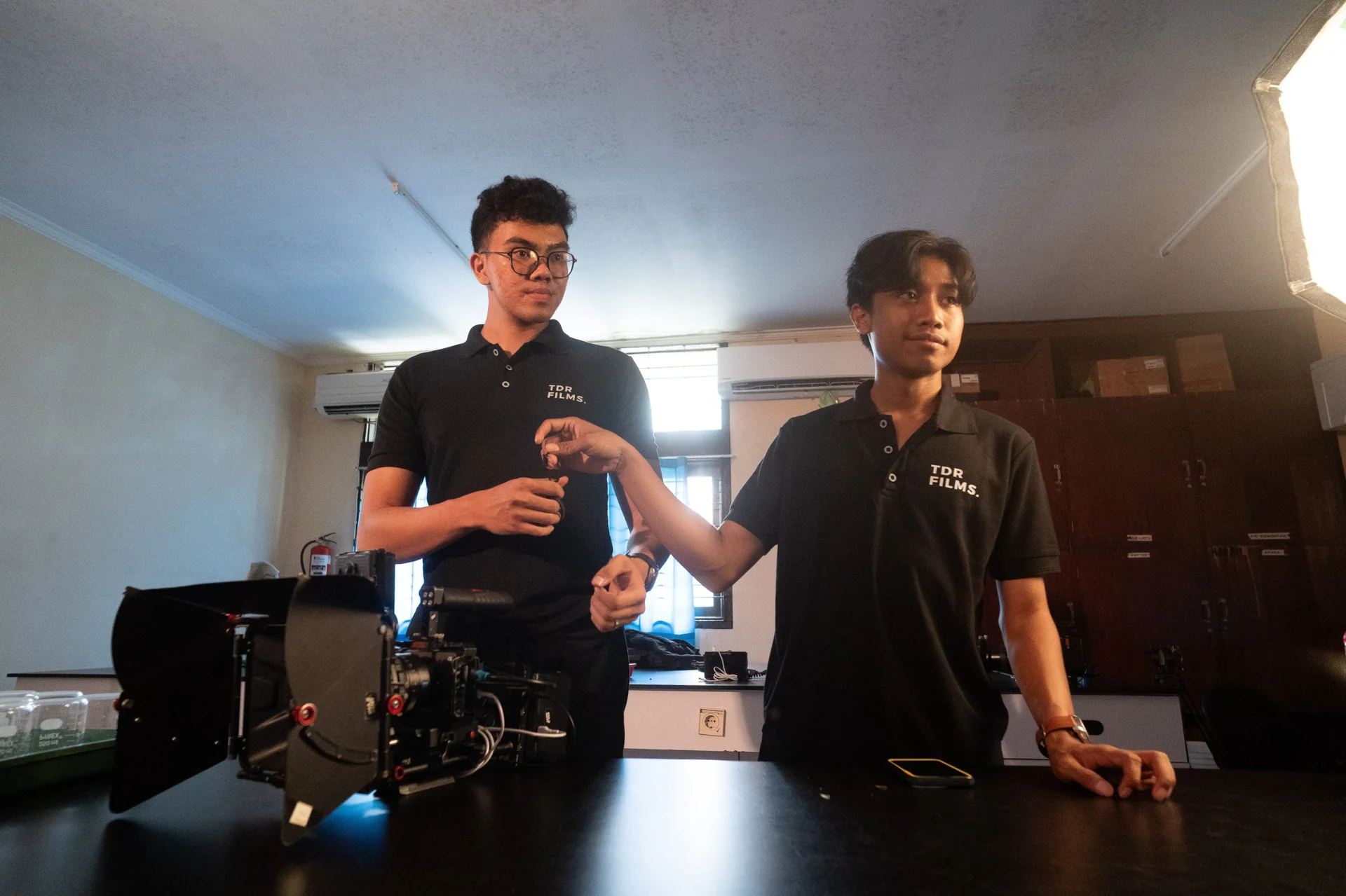 TDR FILMS crew preparing camera equipment on location for an NGO video production partner project